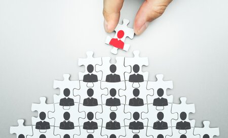 Puzzle pieces with outlines of people